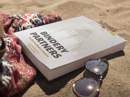 Perfect-Binding-Bound-Service-book-lying-on-the-beach-Commercial-Binding-Service