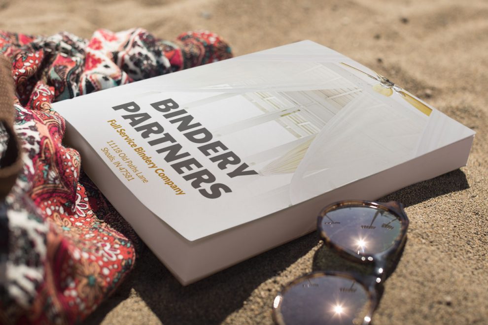 Perfect-Binding-Bound-Service-book-lying-on-the-beach-Commercial-Binding-Service